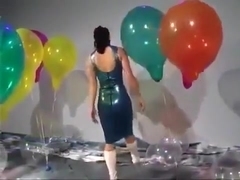 Sexy Girl In Latex Dress Blows to Pop Some Big Balloons