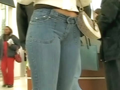 Sexy Latina girl in jeans followed by voyeur