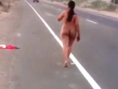 Latina girl walking nude by the road