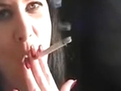 Sexy brunette hoe smokes a cigarette