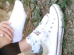 Chinese girl sprains foot in white ankle socks and black leggings