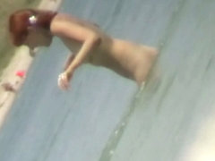Beach spy cam catches a readhead girl running into the water