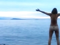 Naked woman greets the beauty of the sea