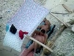 Spotter tapes couple having enjoyment on beach
