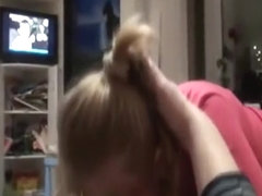 Ponytailed girl sucks cock and swallows on the sofa, while her man watches tv.