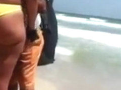 Woman with a big ass on the beach