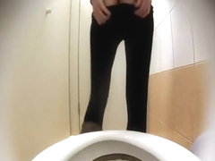 Woman takes a leak in toilet