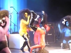 Painted boobs bounce around on the stage at a rock concert