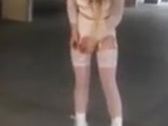 Sexy schoolgirl in white lingerie walks outside.