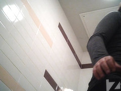 Long-haired cutie with unshaved beaver relaxes in the toilet