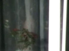 Naked mature woman caught from bedroom window by a voyeur