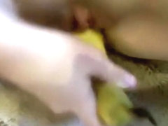 girl wildly masturbates with a banana on the floor and moans