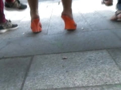 Candid orange mules and pantyhose