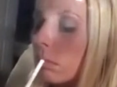 Hot blonde lady lights a cigarette and smokes so seductively