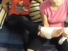 girls hurting and bandaging each other's feet.