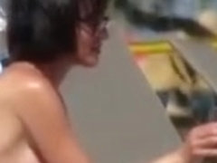 Short hair woman topless at beach