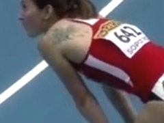 Athletic woman runs around the track in a flimsy outfit