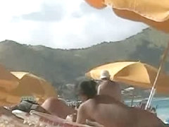 Beach voyeur video of a nude milf and a nude Asian hottie