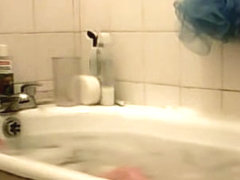 Young bimbo voyeured washing in the soaped bath