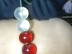 Chick Puts Some Big Beads In Her Butt