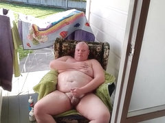 Fat man masturbates by a public road.